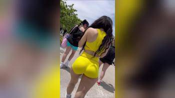 video of yellow booty shorts clapping while walking