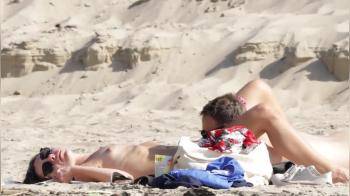 video of Couple caught being naughty on the beach