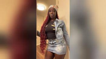 video of Black Woman posing in denim skirt