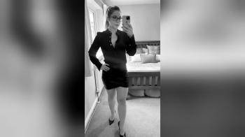 video of Brunette posing in leather mini skirt
